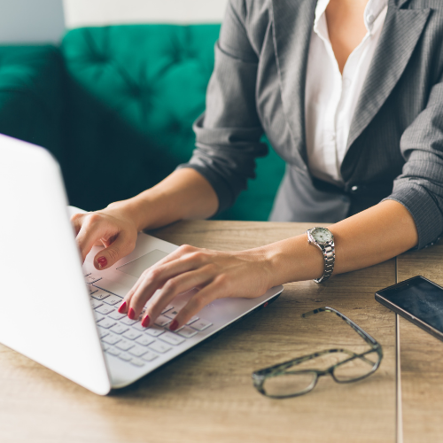 Woman typing on a laptop keyboard.