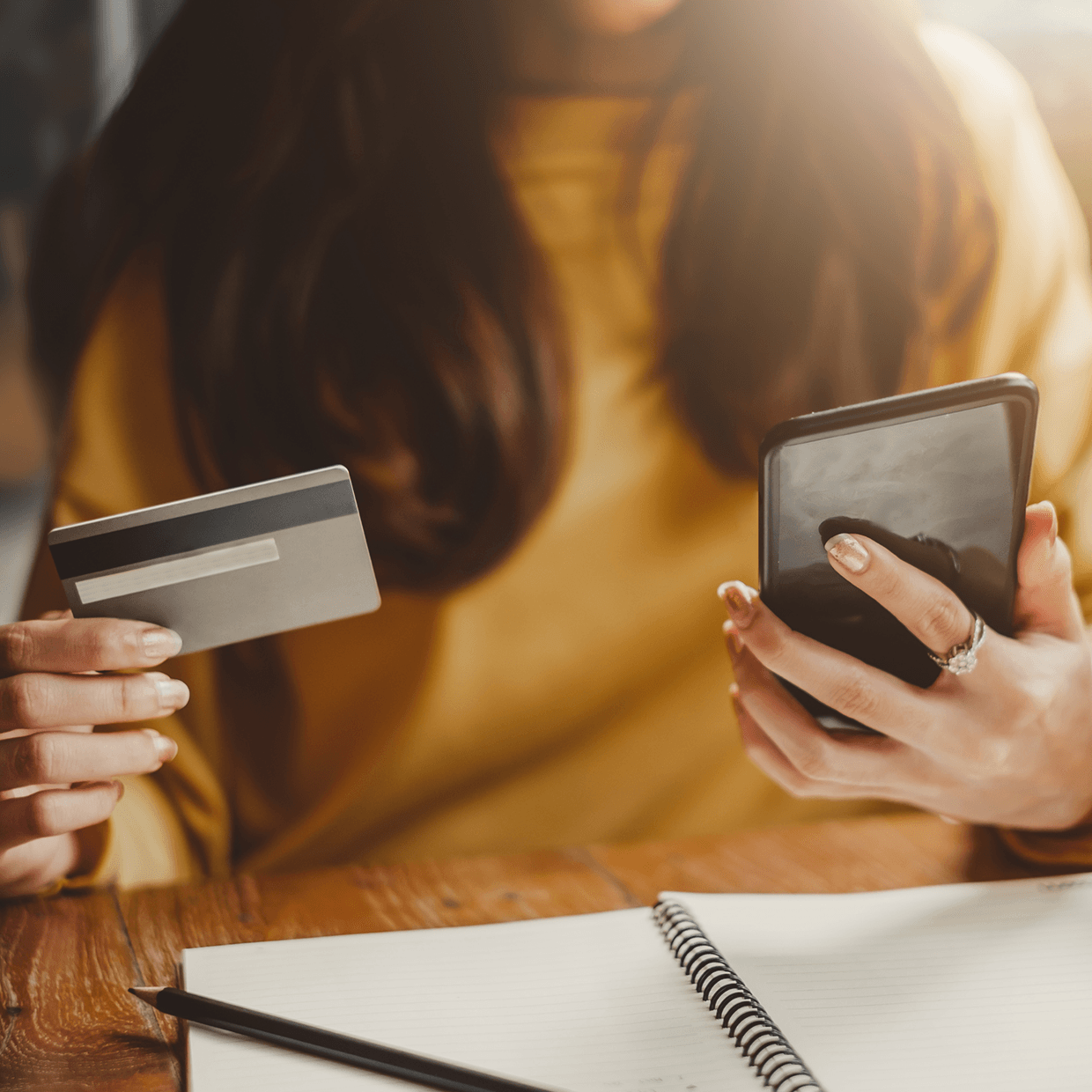 Woman using her phone as a credit card.