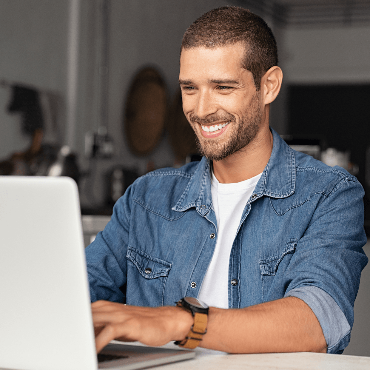 Smiling man at laptop.
