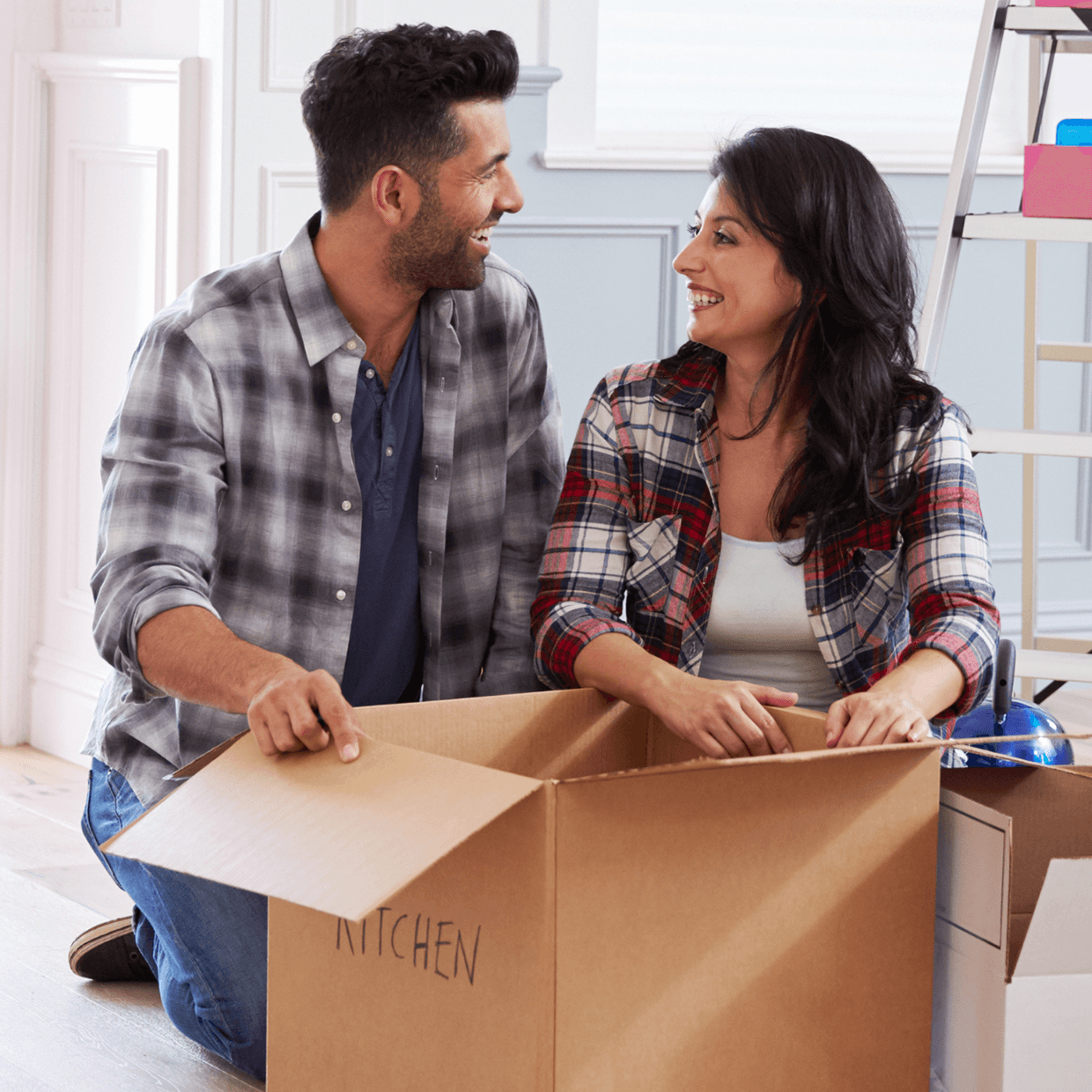 Man and woman unpacking a box.