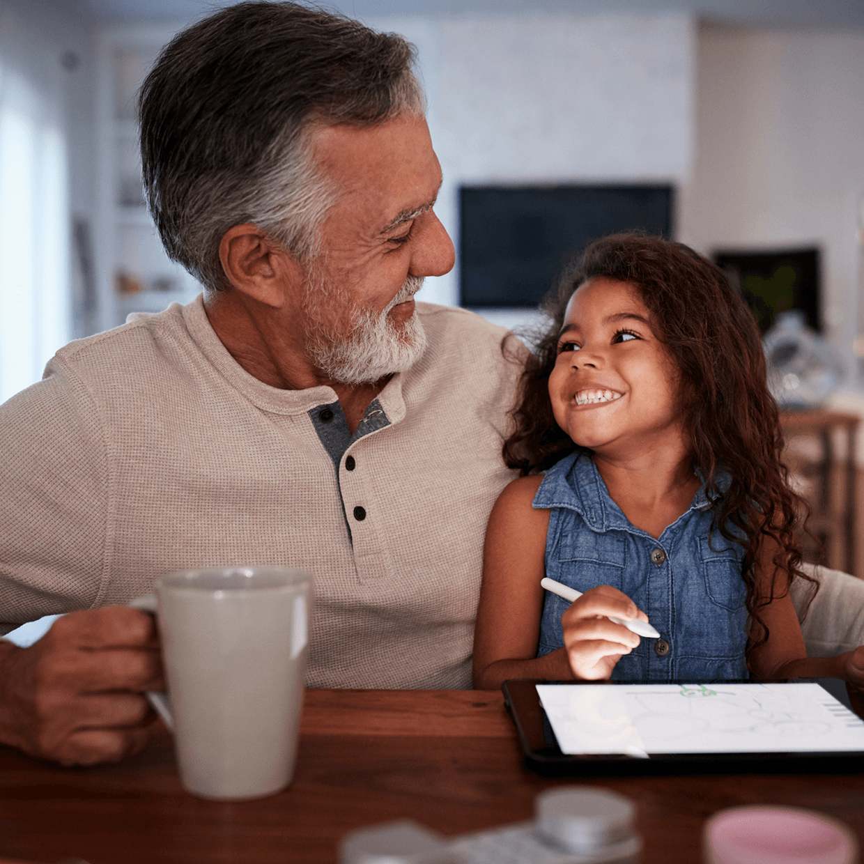 Grandpa coloring with a little girl.